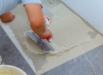 Floor tiles installation. Ceramic tiles and tools for home improvement, renovation